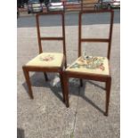 A pair of Edwardian mahogany bedroom chairs with floral needlework tapestry drop-in upholstered