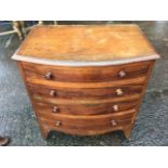 A Victorian mahogany commode, the bowfronted moulded top above four dummy knobbed drawers, having