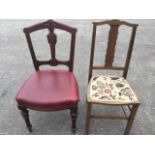 A Victorian dining chair with carved back above a stuffover upholstered seat raised on turned