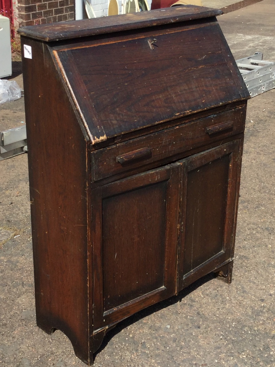 An oak bureau, the cleated fallfront above a long drawer and panelled chamfered cupboards. (30in x - Image 2 of 3