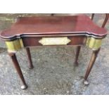 A George II mahogany turn-over-top tea table with rounded projecting corners, the frieze with