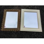 A painted cushion framed mirror with beaded border; and a Victorian style gilt framed mirror with