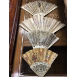 Four handpainted ivory fans - the sticks all with carvings, some with applied sequins, floral