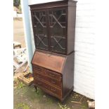 An Edwardian mahogany boxwood strung bureau bookcase, with moulded cornice above astragal glazed