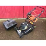 An electric Hayter Hobby executive lawnmower with long cable and grass box.