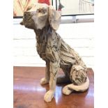 A bark style carved dog seated on its haunches. (16in)