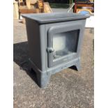 A DeLonghi electric heater in the form of a stove with glazed door enclosing faux coals. (20.5in x