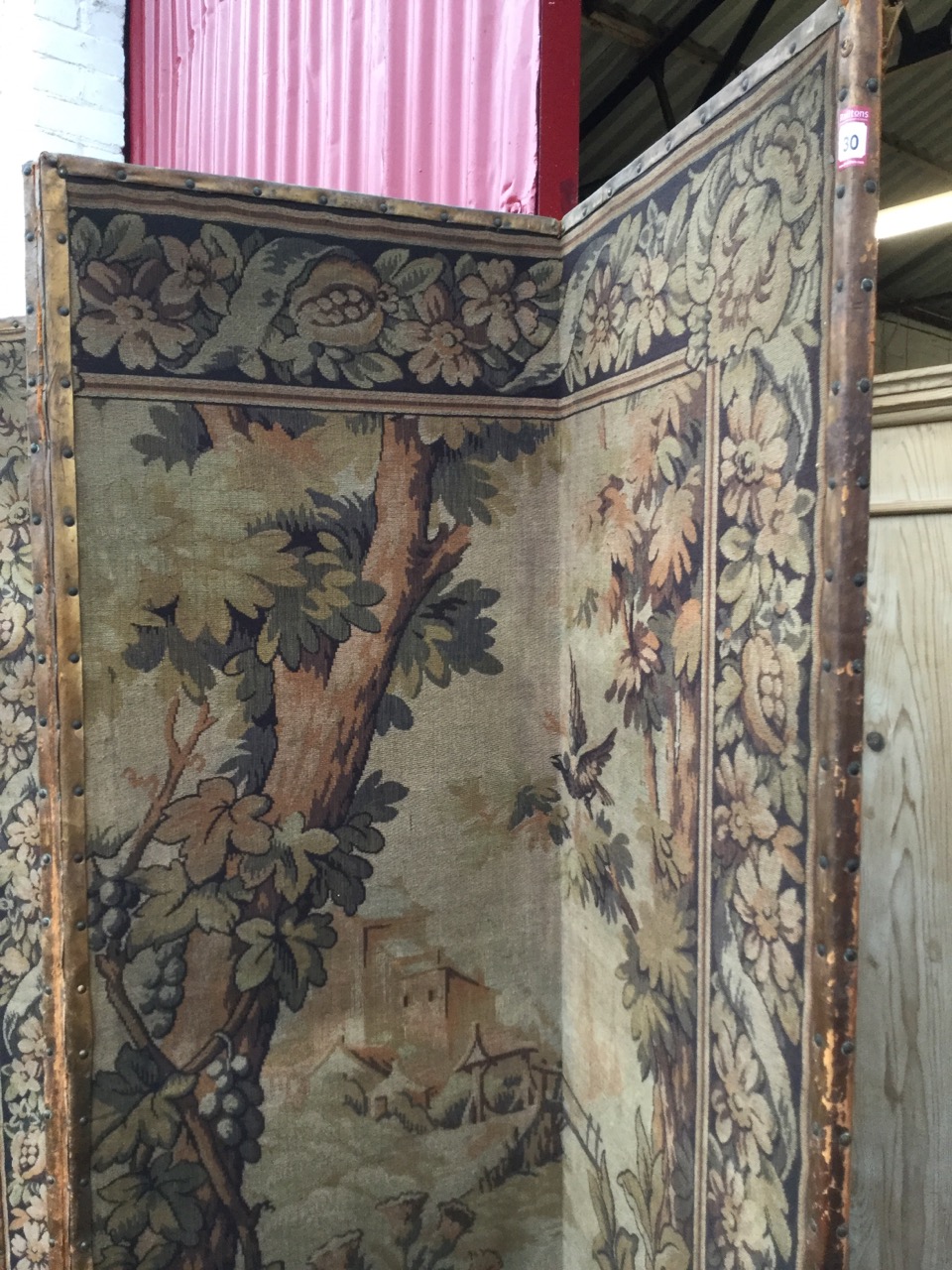 A tall four-fold antique tapestry screen, the woven panels depicting birds in landscapes framed by - Image 3 of 3