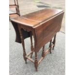 A nineteenth century mahogany sutherland table, the scalloped moulded top carved with shaped