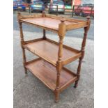 A Victorian three-tier mahogany dumb waiter, the tray platforms supported on baluster turned columns