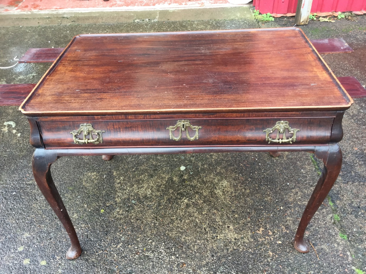 A large Georgian mahogany silver table, the cut-corner tray top above a cushion moulded frieze