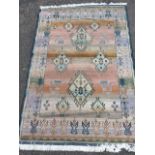 An oriental style Gabbeh wool rug woven in striped pastel tones, the field of hooked lozenges and