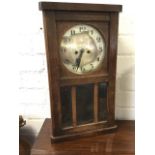 A 30s oak cased wallclock, the circular German silvered dial above three panes of bevelled glass