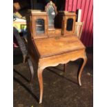 A nineteenth century rosewood marquetry bonheur-de-jour, inlaid with urns, floral medallions, bows