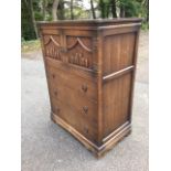 An Old Charm oak cabinet with rectangular moulded top above a pair of panelled doors having