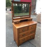 A late Victorian satin walnut dressing table, the mirror with bevelled plate on shaped tapering