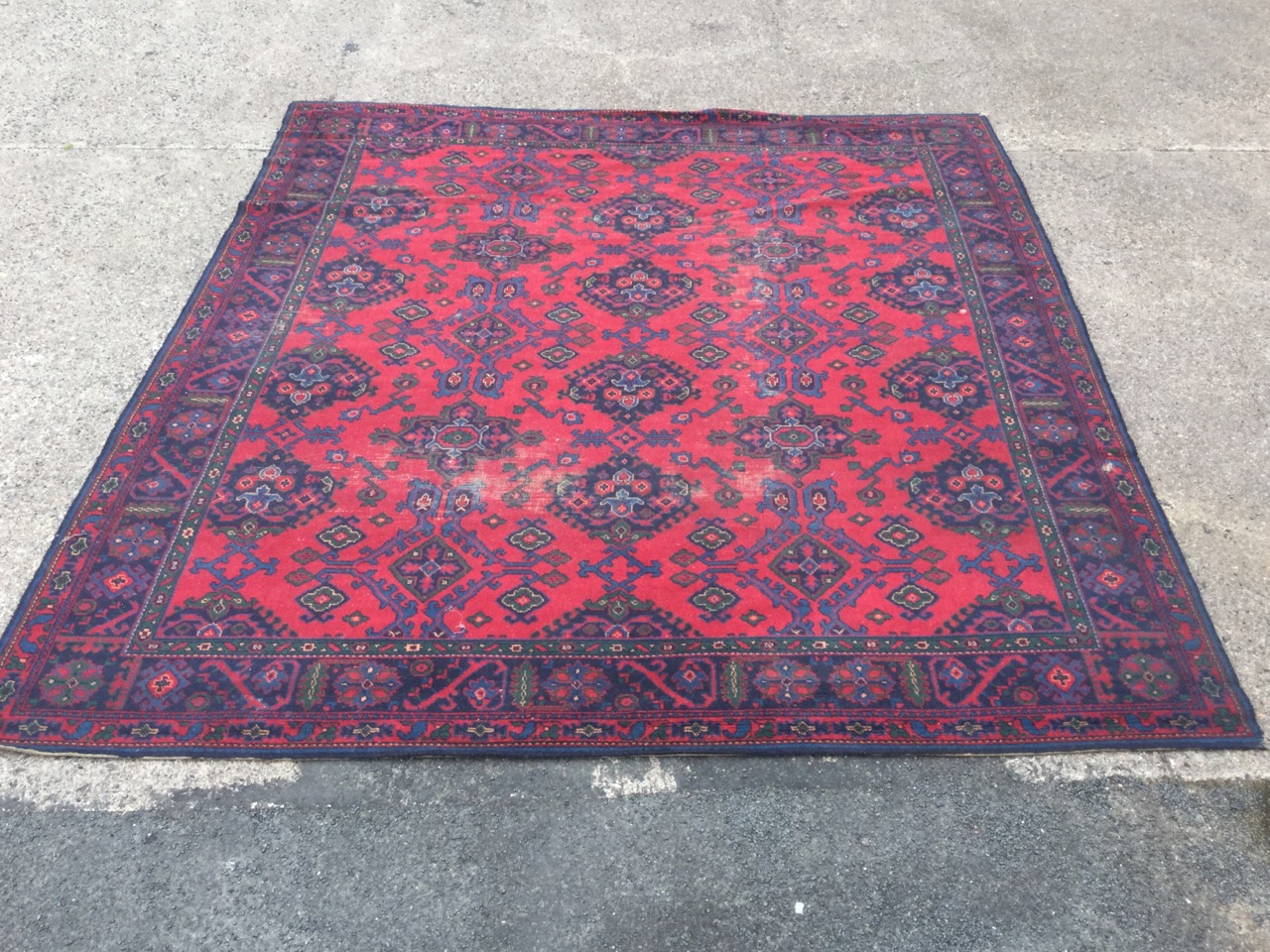 A Turkish carpet woven in the traditional green & blue palette on red ground - some wear. (124in x