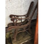 A pair of cast iron bench ends with scrolled arms and channelled frames supported on sabre legs -