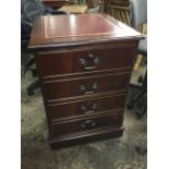 A panelled reproduction mahogany filing cabinet, the moulded top set with gilt tooled leather skiver