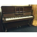 An overstrung walnut cased upright piano by William Thomson & Sons, having seven octave keyboard