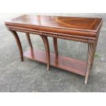 A contemporary mahogany hall table, the rectangular moulded top with marquetry banding above a