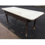 A rectangular pine table with later formica board top, the original plank top having deep frieze,