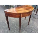 A nineteenth century 'D' shaped mahogany turn-over-top card table, the crossbanded top having