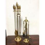 A set of brass firetools on weighted stand with urn style handles - poker, shovel, brush & tongs;