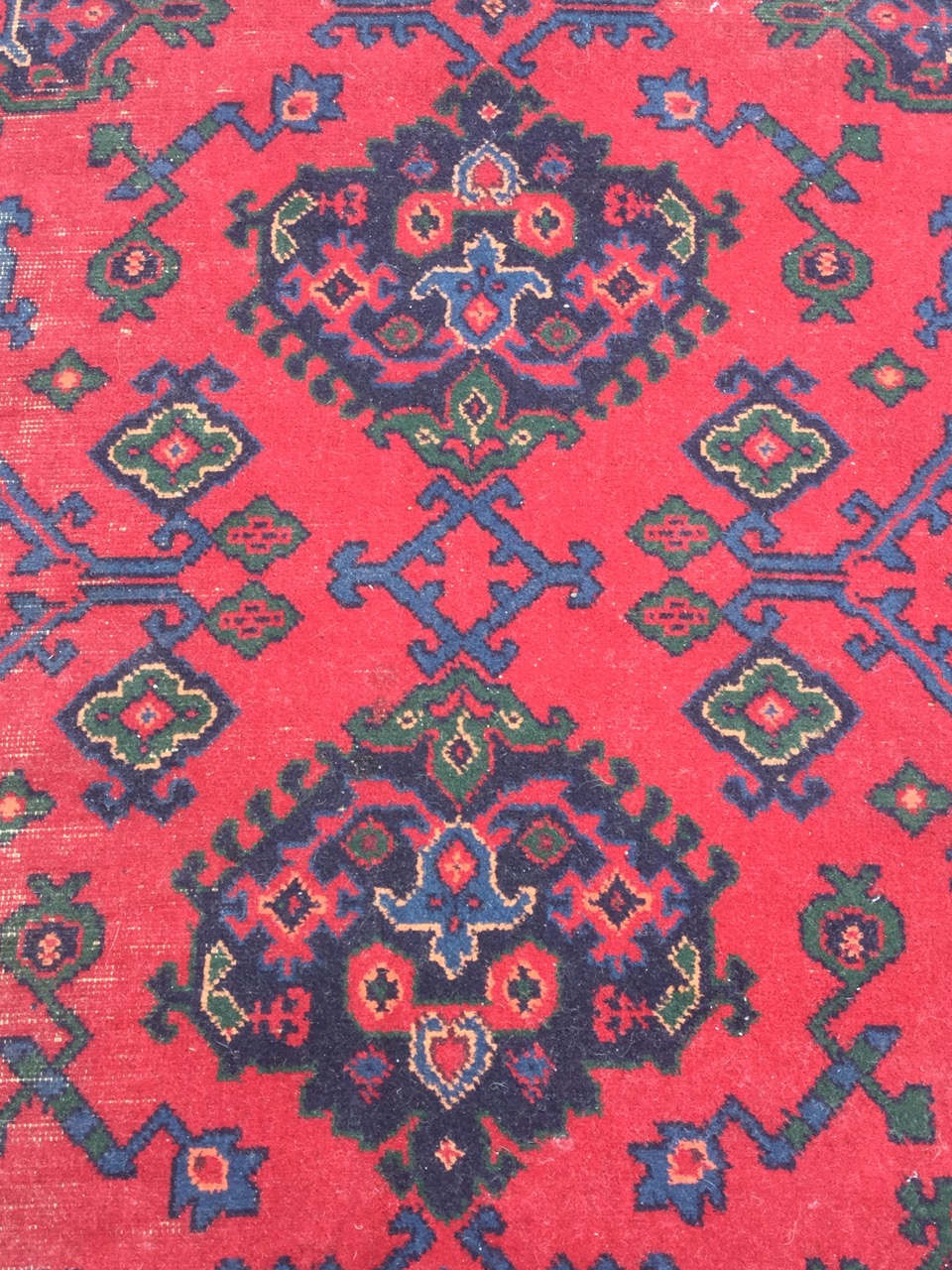 A Turkish carpet woven in the traditional green & blue palette on red ground - some wear. (124in x - Image 3 of 3