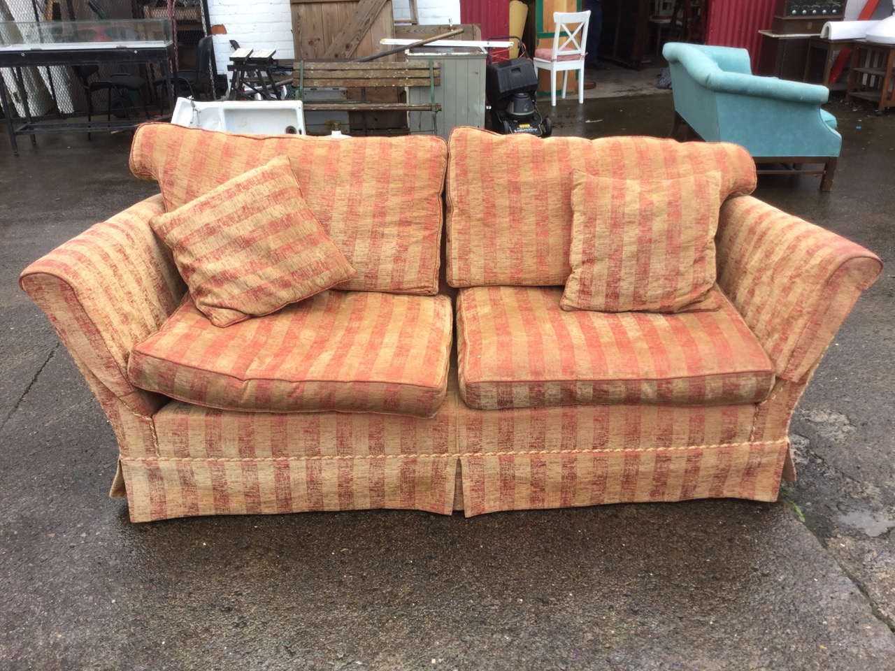 A contemporary sofa upholstered in striped gold & maroon brushed velour, having loose cushions and