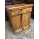 A late Victorian walnut sewing machine cabinet, the rectangular moulded top above cross-fluted doors
