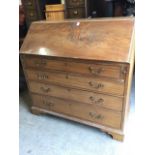 A Georgian mahogany bureau, the fallfront enclosing a fitted interior with drawers, pigeonholes