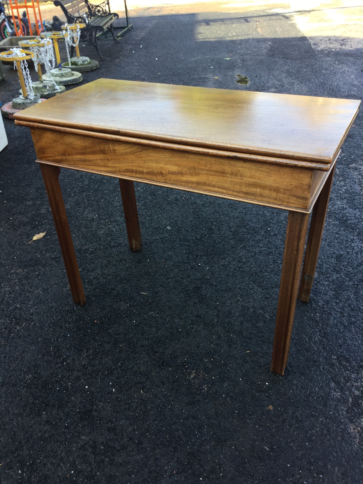 A nineteenth century mahogany turn-over-top tea table, the rectangular twin flaps above a plain