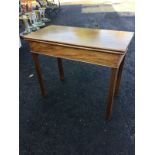 A nineteenth century mahogany turn-over-top tea table, the rectangular twin flaps above a plain