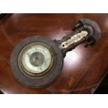 A Victorian carved mahogany barometer, with arch and turned mouldings framing glass thermometer