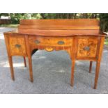 A nineteenth century Sheraton style serpentine fronted mahogany sideboard, with later stepped