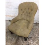 A small Victorian button upholstered chair, the spoonback above rounded arms and sprung seat, raised