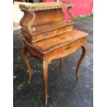 A nineteenth century rosewood & burr yew bonhour-de-jour, with crossbanded serpentine shelves framed