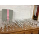A quantity of drinking glasses, mainly in sets including 23 flute cut wine glasses, pairs,