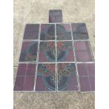 Thirteen rectangular stained leaded glass panels forming a floral style window design, each