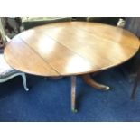 A Victorian oval oak dining table, the top with two drop-flaps supported on a bulbous turned column,