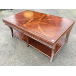 A contemporary mahogany coffee table, the rectangular walnut banded marquetry top above a cushion