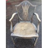 An eighteenth century Hepplewhite style mahogany open armchair, the shield shaped back with