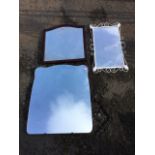 A rectangular mirror in painted scrolled wrought iron frame with applied leaves; a frameless