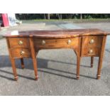 A nineteenth century serpentine fronted mahogany sideboard, the crossbanded top inlaid with