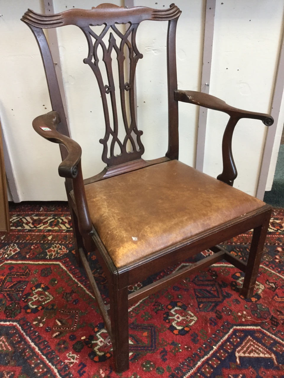 A Chippendale style Victorian mahogany open armchair, the back with fretwork pierced splat beneath