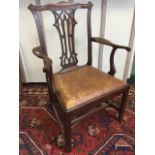 A Chippendale style Victorian mahogany open armchair, the back with fretwork pierced splat beneath
