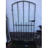 An arched wrought iron garden gate with tubular rails in rectangular frame. (28.25in x 59in)
