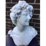 A carved marble bust of a young lady with vines in her hair. (22.5in)