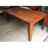 A plain rectangular solid hardwood kitchen table on square tapering legs. (71in x 35.5in x 29.5in)